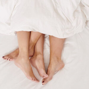 Feet Man And Woman Under Sheets